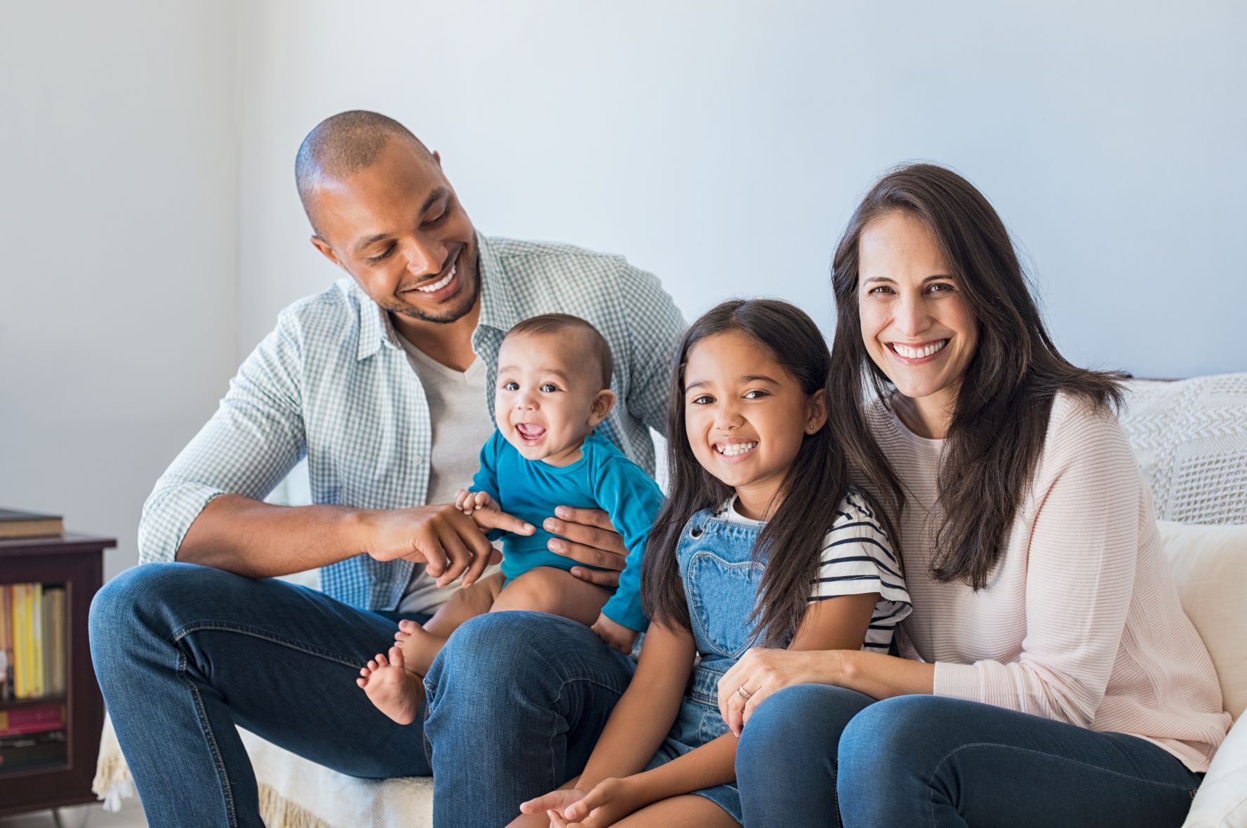 student family sitting on couch